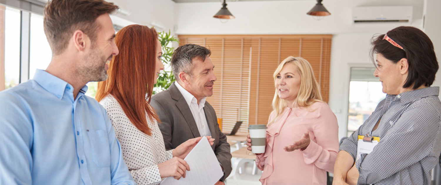 Colleagues standing in office talking